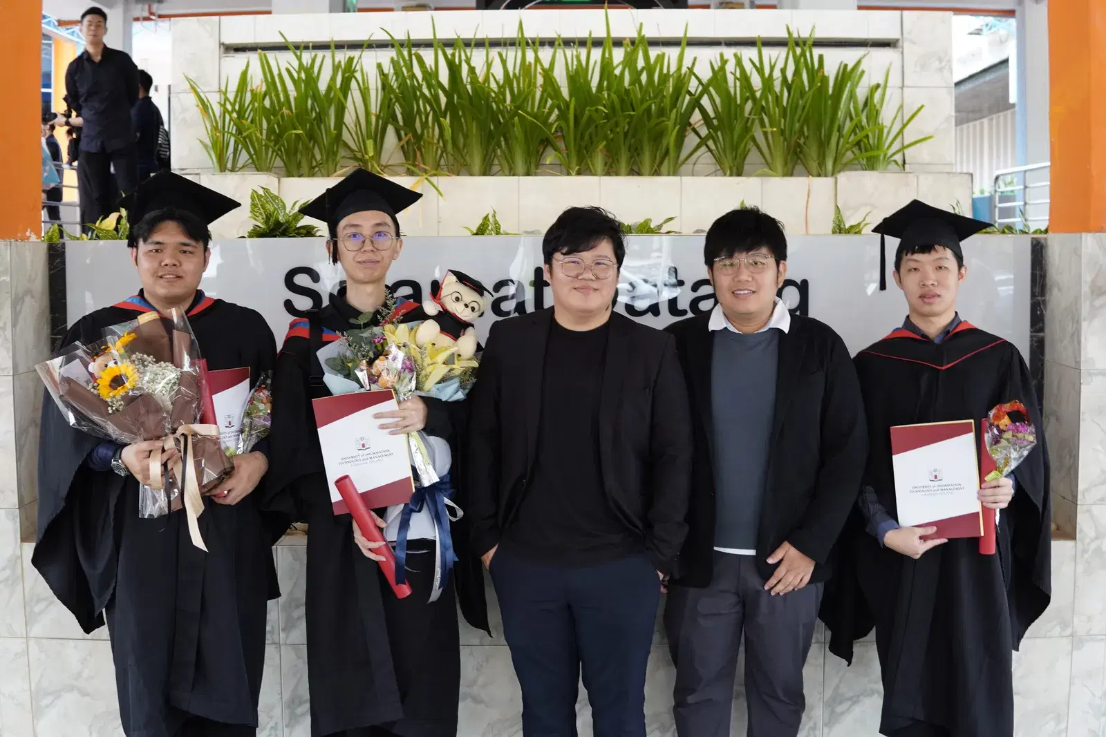 Graduates Celebrating with Diplomas